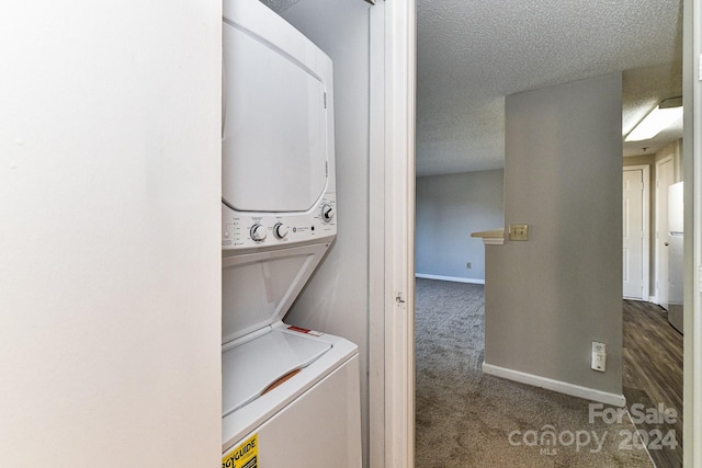 washroom featuring stacked washer / dryer, a textured ceiling, and dark hardwood / wood-style flooring