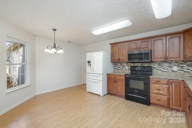 kitchen featuring white fridge with ice dispenser, light hardwood / wood-style flooring, backsplash, black / electric stove, and pendant lighting