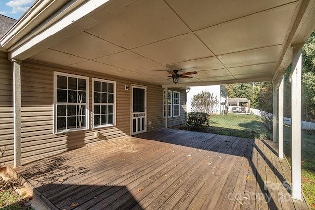 deck featuring a yard and ceiling fan