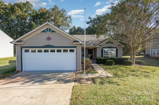 view of front of property with a front lawn and a garage