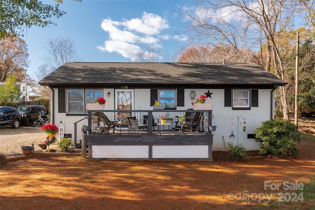 back of house featuring a wooden deck