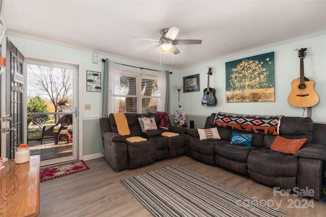 living room with ceiling fan, light hardwood / wood-style floors, and crown molding