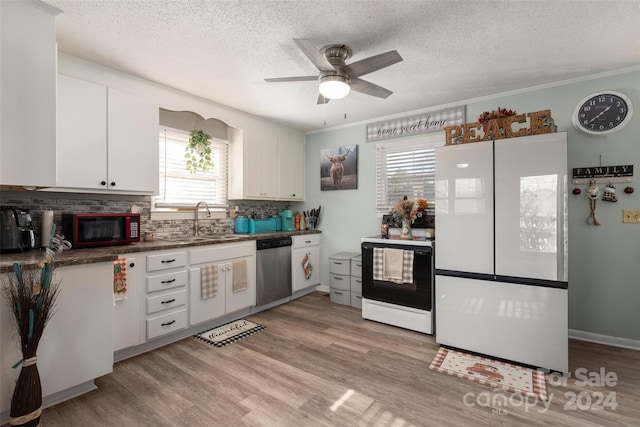 kitchen featuring ornamental molding, white appliances, sink, light hardwood / wood-style flooring, and white cabinets