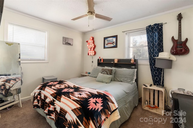 carpeted bedroom with ceiling fan and ornamental molding