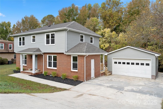 view of front property featuring a garage, central air condition unit, and an outbuilding