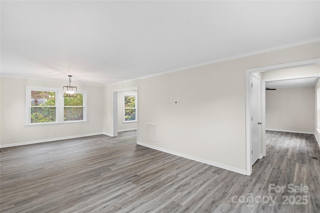 unfurnished room with dark hardwood / wood-style flooring, a wealth of natural light, and ornamental molding