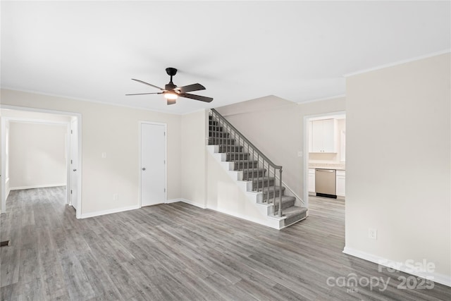 unfurnished living room featuring hardwood / wood-style flooring, ceiling fan, and ornamental molding