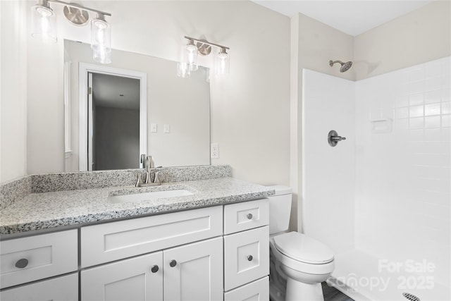 bathroom with vanity, toilet, and walk in shower