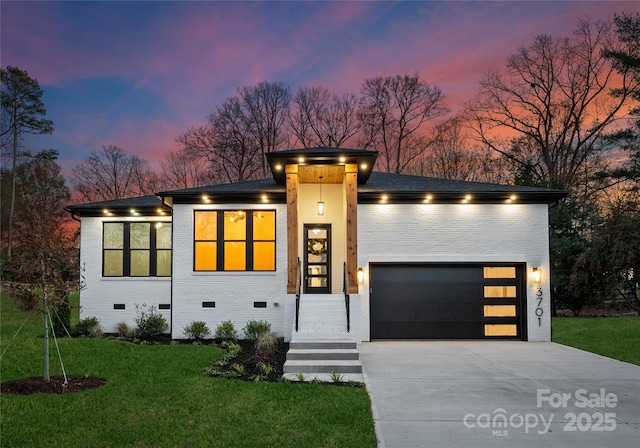 contemporary house with a yard and a garage