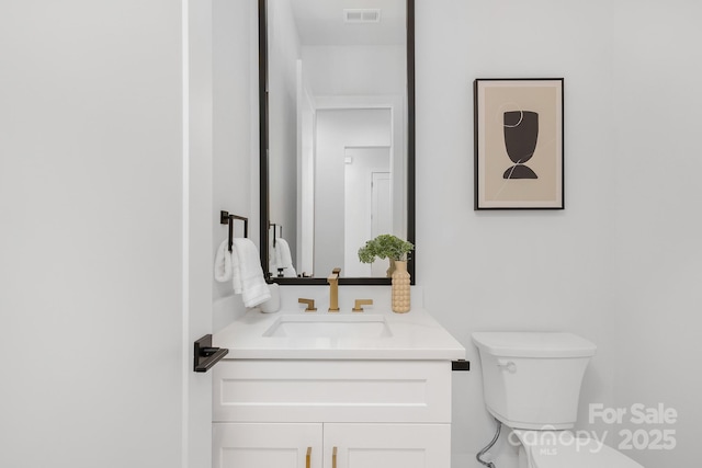 bathroom featuring vanity and toilet