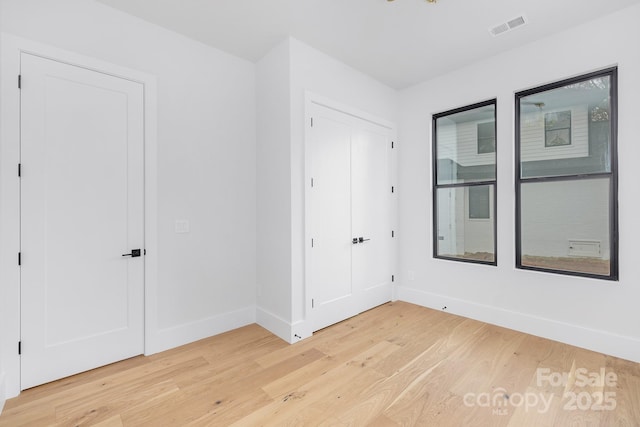 unfurnished room with wood-type flooring