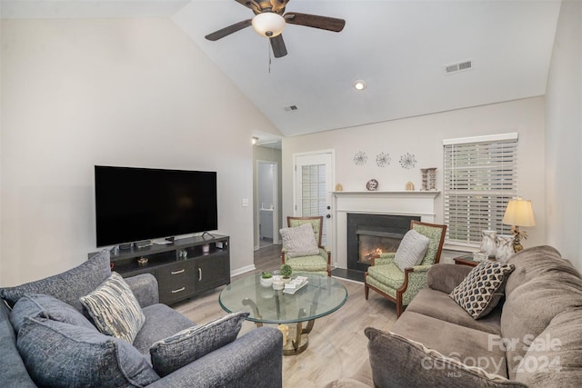 living room with high vaulted ceiling, light wood-type flooring, and ceiling fan