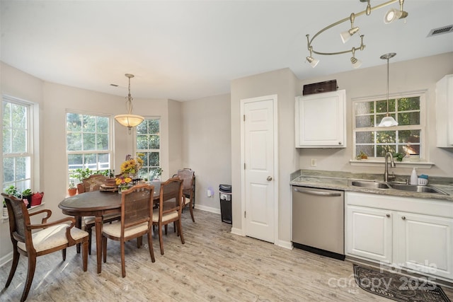 dining space with sink and light hardwood / wood-style flooring