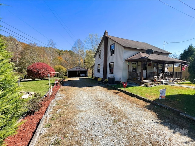 view of front facade with central air condition unit, a front yard, and covered porch