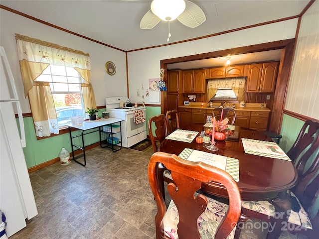 dining space featuring ceiling fan and crown molding