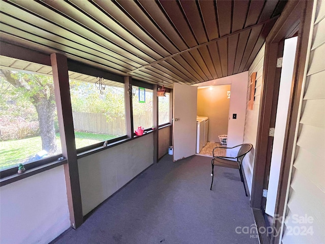 sunroom / solarium featuring washer and dryer and plenty of natural light