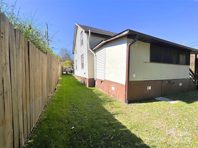 view of side of property with a yard