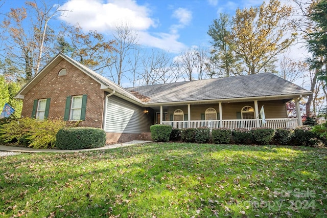 single story home featuring a front lawn and covered porch