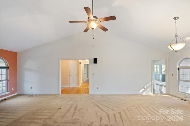 interior space featuring high vaulted ceiling, light colored carpet, and ceiling fan