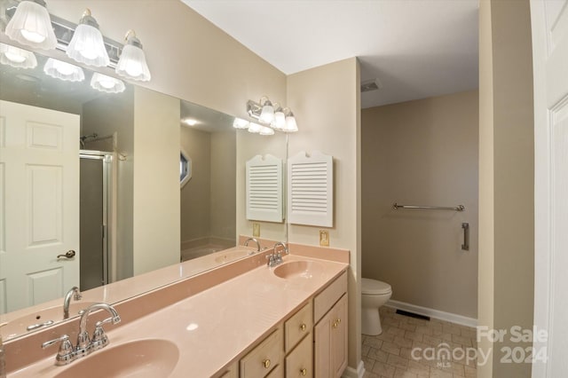 bathroom with toilet, an enclosed shower, vanity, and tile patterned floors