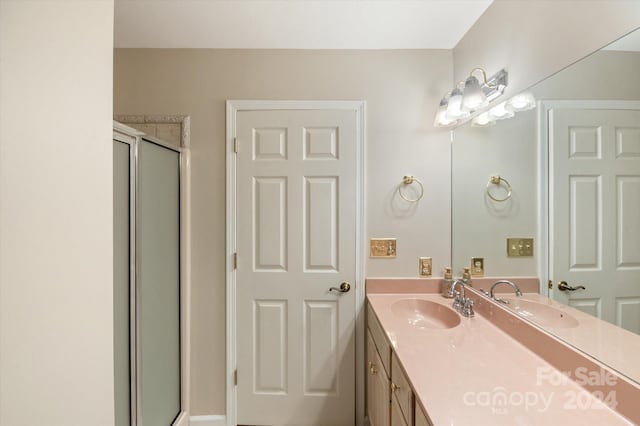 bathroom with vanity and an enclosed shower