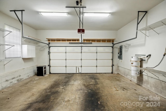 garage featuring a garage door opener and electric panel