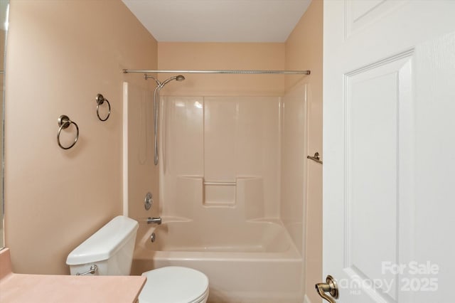 bathroom with toilet, tub / shower combination, and vanity