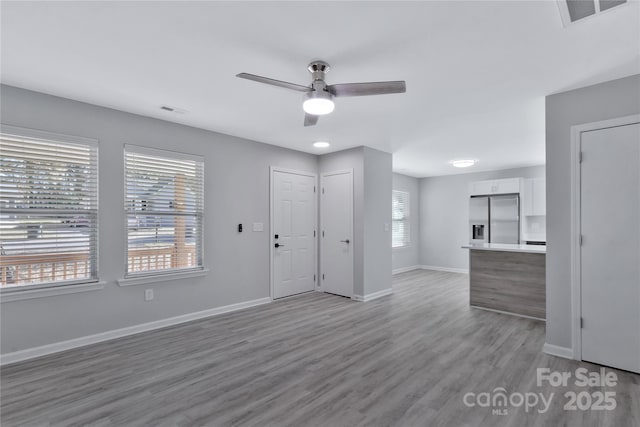 interior space with light hardwood / wood-style flooring and ceiling fan