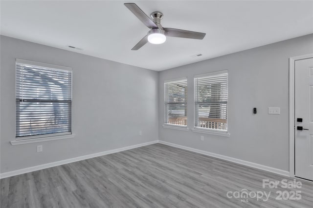 unfurnished room with light wood-type flooring and ceiling fan