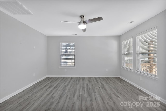 spare room with hardwood / wood-style flooring and ceiling fan