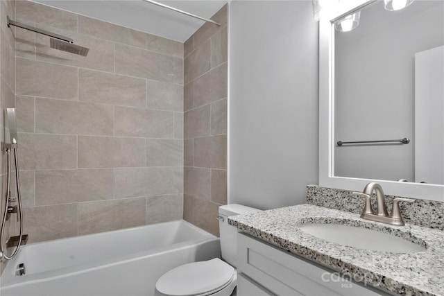 full bathroom with tiled shower / bath combo, vanity, and toilet