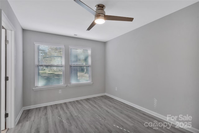 unfurnished room featuring ceiling fan and light wood-type flooring