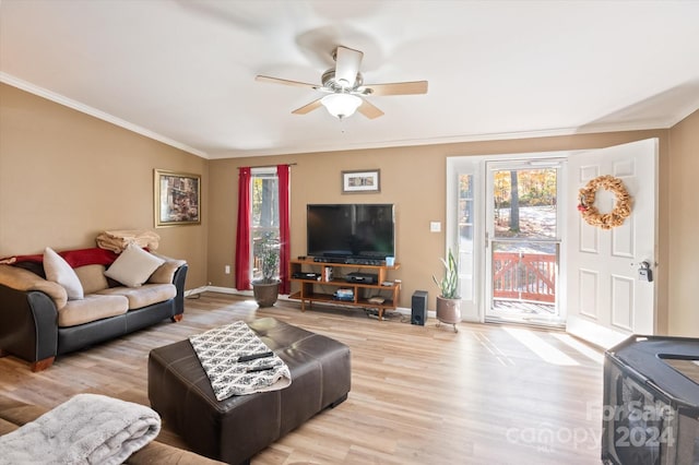 living room featuring ornamental molding, light wood-type flooring, and ceiling fan