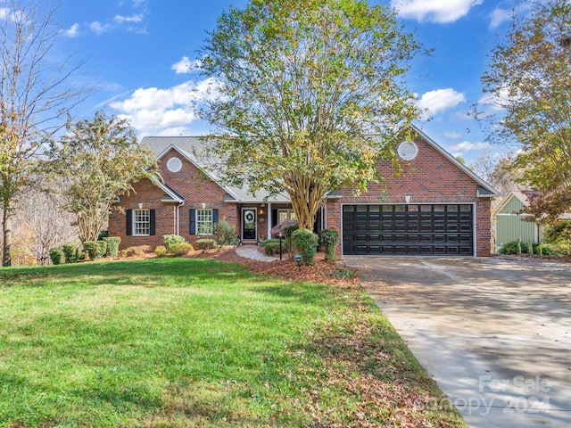 view of front of property featuring a garage and a front yard