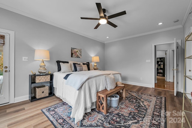 bedroom with ceiling fan, ornamental molding, and light wood-type flooring