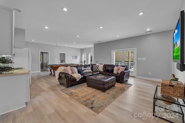 living room featuring light hardwood / wood-style floors, billiards, and french doors