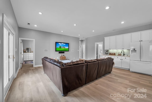 living room with sink and light wood-type flooring