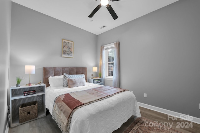 bedroom featuring vaulted ceiling, ceiling fan, and dark wood-type flooring