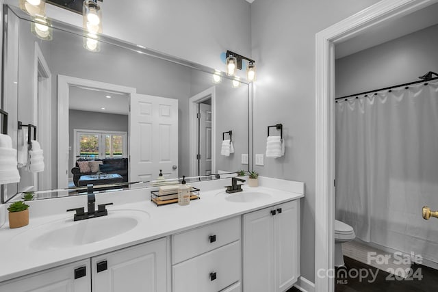 full bathroom featuring vanity, toilet, and shower / tub combo with curtain