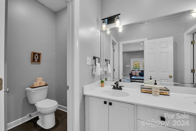 bathroom featuring vanity and toilet