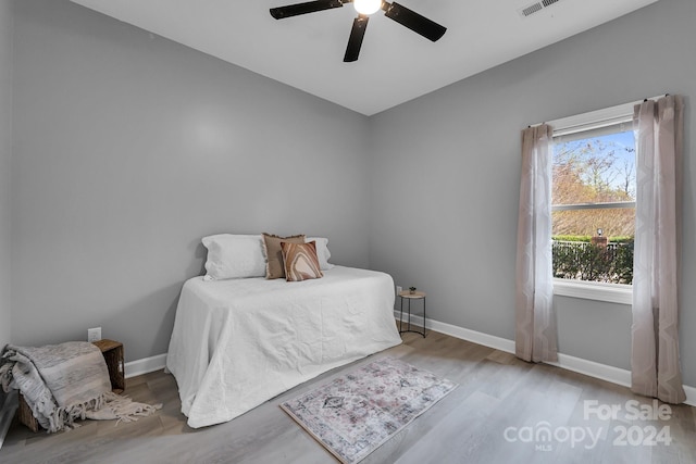 bedroom with ceiling fan and hardwood / wood-style flooring