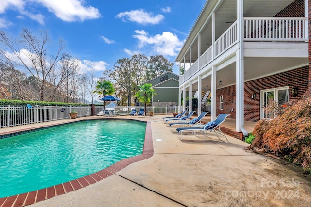 view of swimming pool with a patio