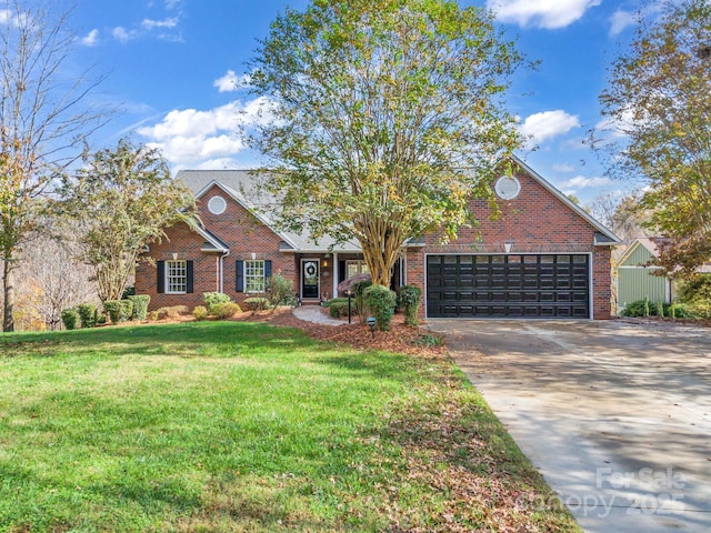 view of front of property with a garage and a front lawn