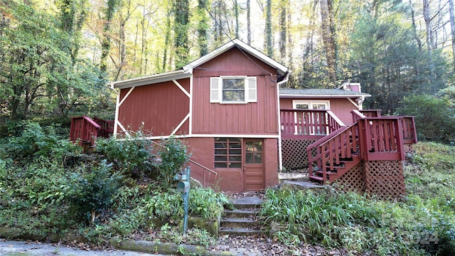 back of house with a wooden deck