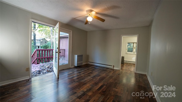 unfurnished room with dark wood-type flooring, ceiling fan, a textured ceiling, and a baseboard heating unit