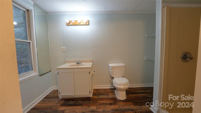 bathroom with vanity, toilet, and wood-type flooring