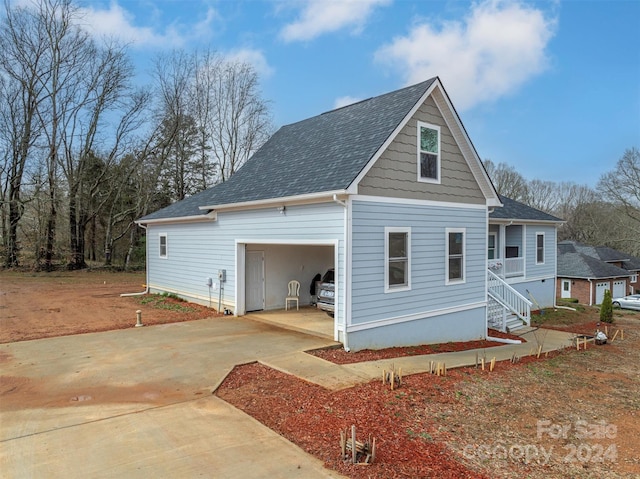 rear view of house with a garage