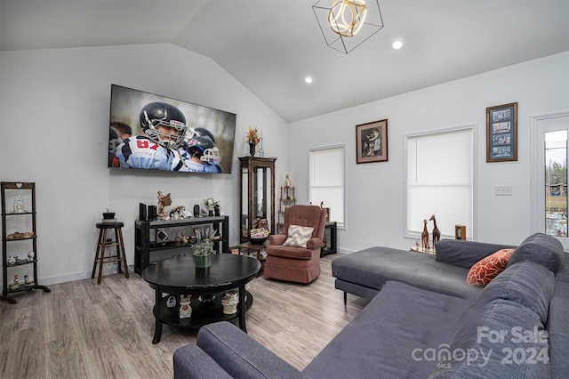 living room featuring vaulted ceiling and wood-type flooring