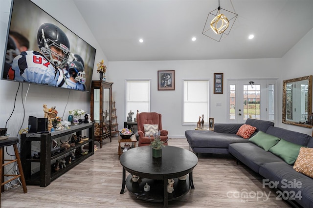 living room with vaulted ceiling and light hardwood / wood-style flooring