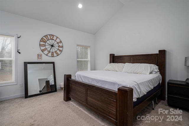 carpeted bedroom featuring vaulted ceiling